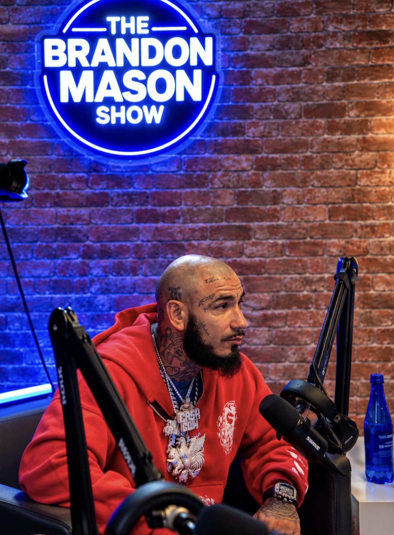 Bryan “Cash Cow” Duran seated at the microphone beneath The Brandon Mason Show sign